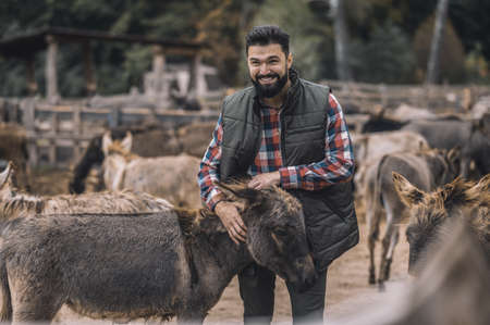 A farmer with his animals at the framの写真素材