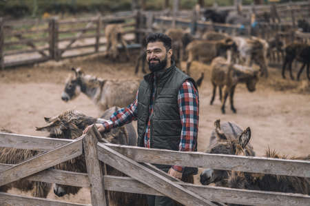 A farmer with his animals at the framの写真素材