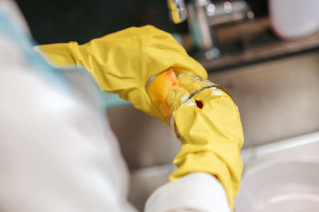 Close up picture of human hands cleaning the glass