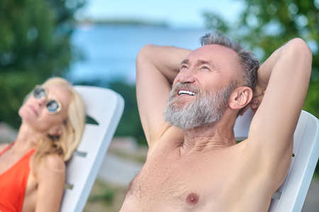 Mature couple sunbathing and feeling relaxedの写真素材