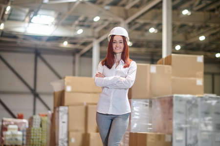 Woman in helmet with arms folded on her chest