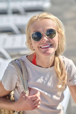 Blonde mid aged woman in sunglasses