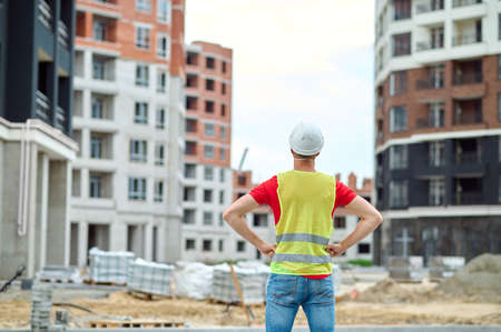 Back view of man looking at construction siteの写真素材