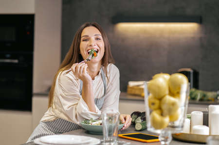 Cute positive woman in the kitchen