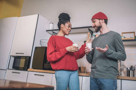 Inspired emotional guy and girl chatting over coffeeの写真素材