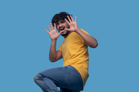 Scared young man showing the Stop gestureの写真素材