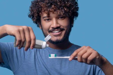 Cheerful man smiling at the camera before the tooth-brushing procedure