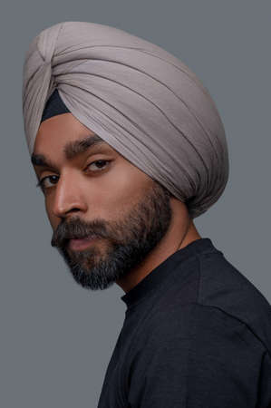 Calm bearded mustached man in the head wrap staring aheadの写真素材