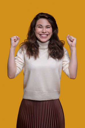 Joyful trendy lady demonstrating her energy before the cameraの写真素材