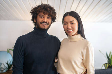 Happy young man and woman looking at cameraの写真素材