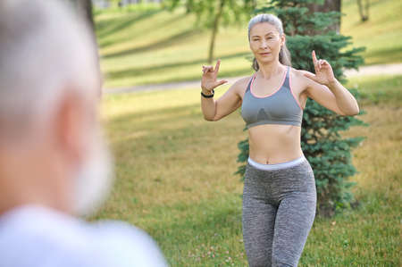 A woman in grey sportswear explaining something to the manの写真素材