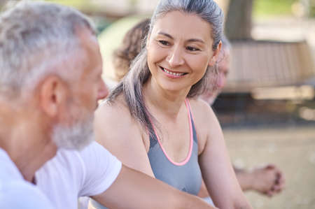 Mid aged people resting in the park after the workoutの写真素材