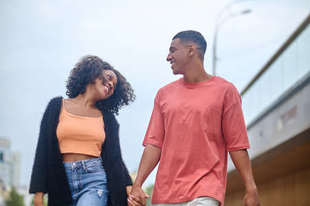 Man and woman looking at each other walking