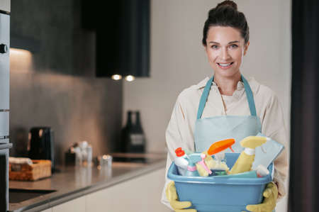 Young smiling woman with a basin with cleansing appliancesの写真素材