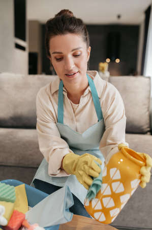 Young woman doing housework and looking busyの写真素材