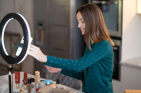Pretty young woman telling the online audience about beauty tips