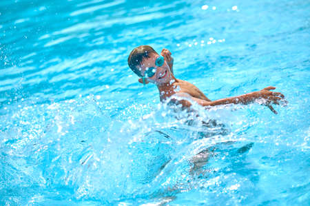 Boy in water making splashes with his hand