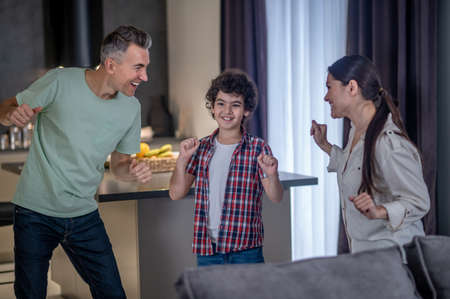 Man woman and boy dancing at homeの写真素材