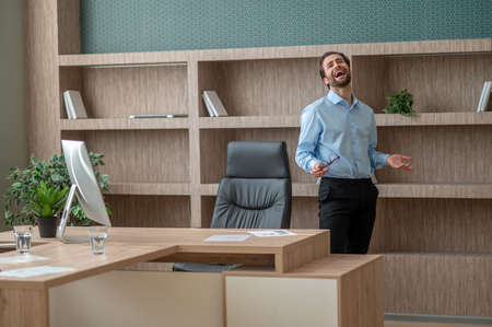 A man standing near the table in the officeの写真素材