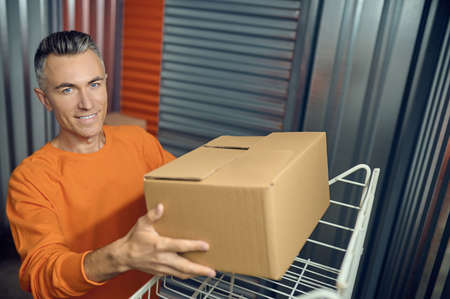 Employee arranging boxed items on the shelving unit