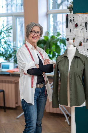 Woman confidently looking at camera standing near dummy,の写真素材