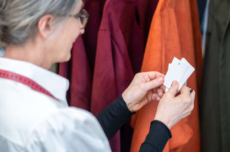 Woman looking at tags for new clothesの写真素材