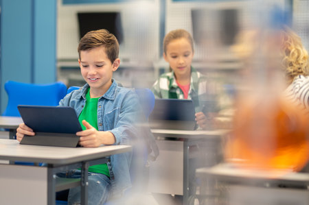 Children looking at tablets in class