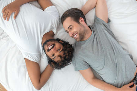 Joyful gay couple resting in their bedroomの写真素材