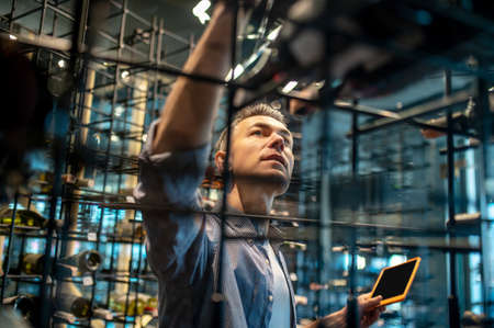 A wine store owner making a revision and looking busyの写真素材