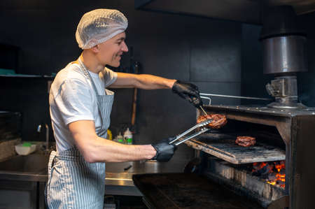 A chief-cooker working in the kitchen in the restaurantの写真素材