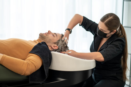 Beautician massaging head to the male customer