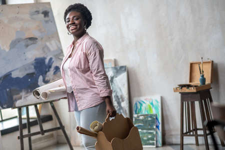 Contented african woman in pink clothes in the art studioの写真素材
