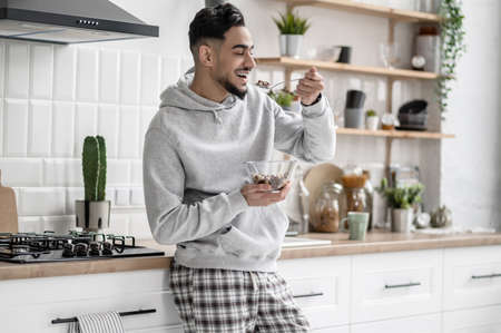 A young man spending morning at home and having coffeeの写真素材