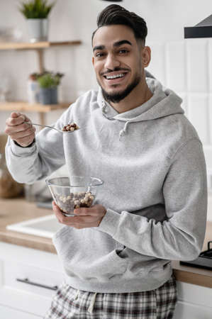 A young man spending morning at home and having coffee