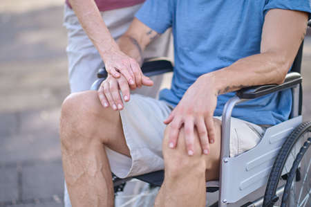 A close up picture of a man sitting in a wheel chairの写真素材