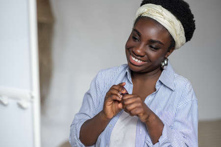 Contented african woman holding mascara in handsの写真素材