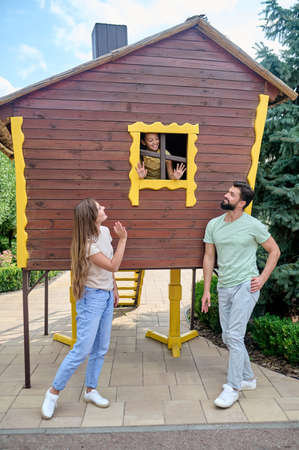 A girl is exploring a small house in a theme parkの写真素材