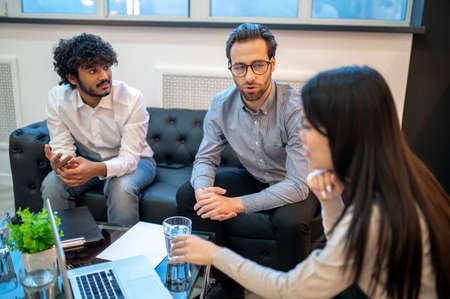 Three company employees sitting around the table