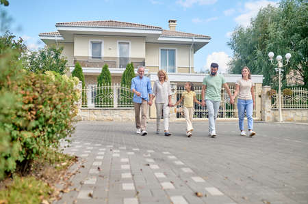 Smiling family walking hand in hand and looking happy