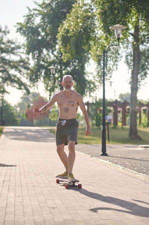 A male skateboarder enjoying a ride in a parkの写真素材