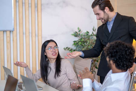 Group of three company workers discussing business matters
