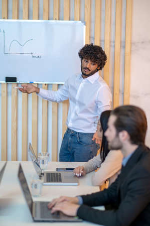 Gesticulating office worker giving a presentation to his coworker
