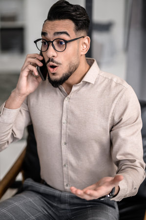 A young good-looking businessman talking on the phone