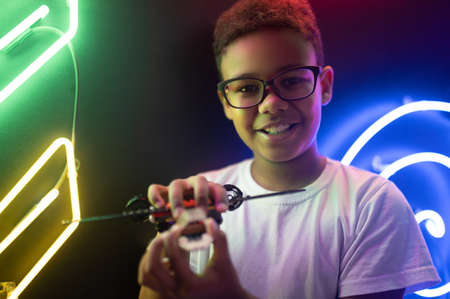 Happy teenage boy holding a toy chopper in his handsの写真素材