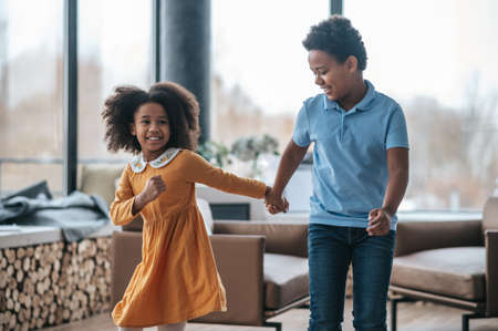A boy and a girl dancing and looking joyfulの写真素材