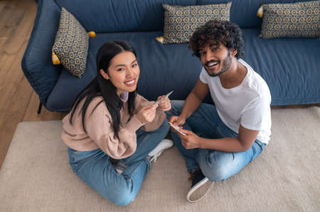 Young couple spending time at home and looking enjoyed