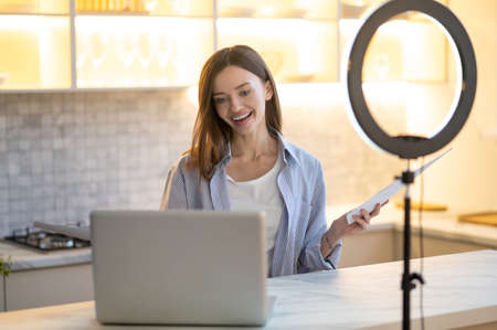 Smiling woman talking looking at laptop screenの写真素材