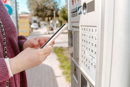 Woman paying for fuel via the smartphoneの写真素材