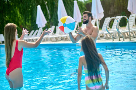 Family of three vacationers in the swimming pool