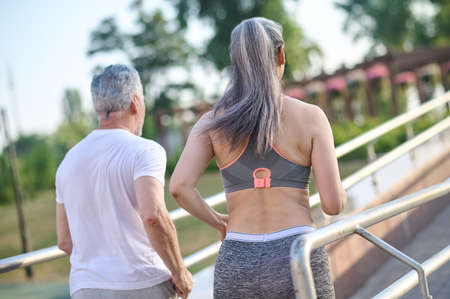 Man and woman in sportswear jogging in the parkの写真素材